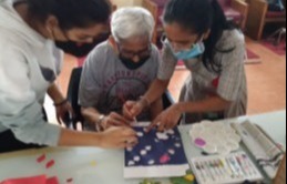 Volunteers with a member at the Centre